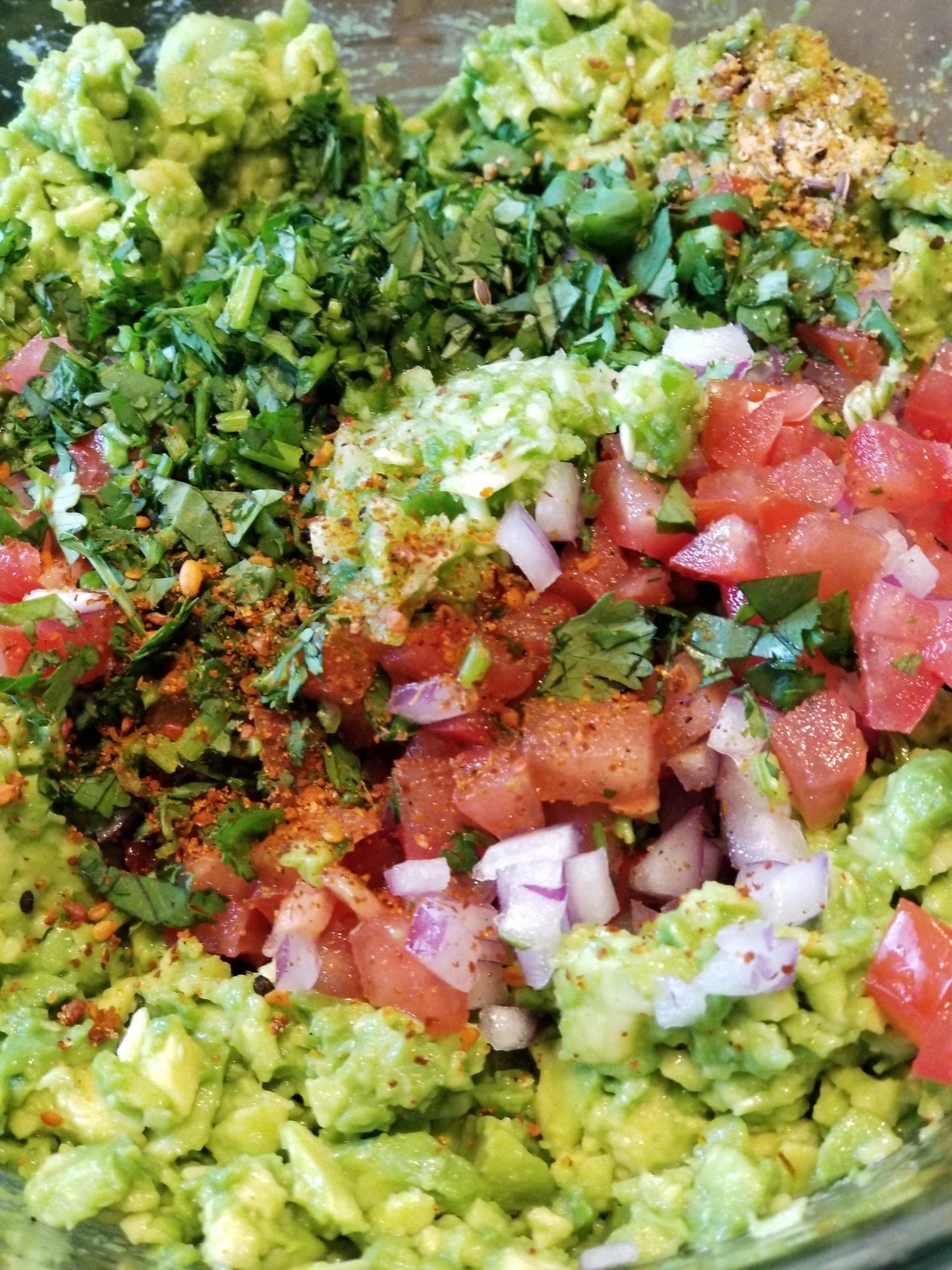 all the fresh guacamole ingredients before mixing
