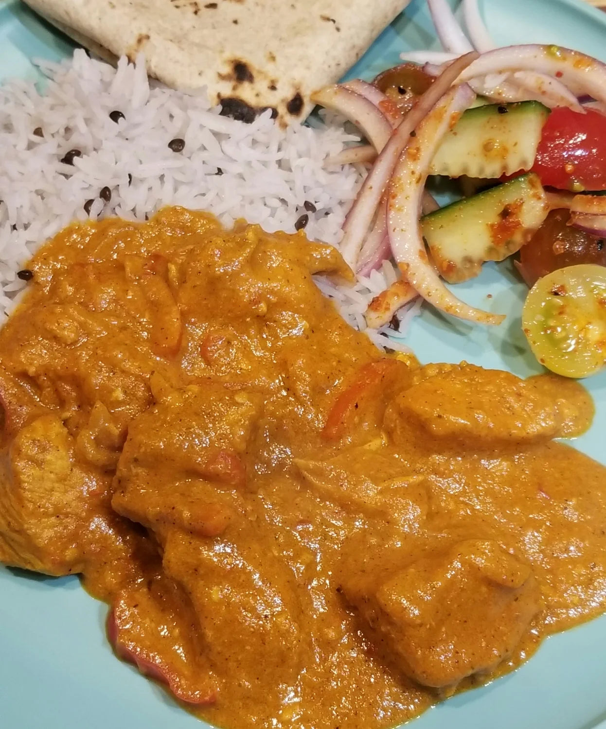 chicken tikka masala curry dish with rice and salad image 