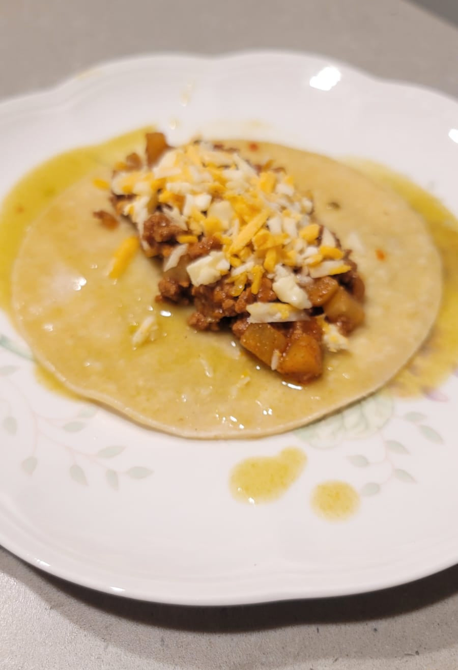 picadillo enchilada before folding with a green sauce and cheese